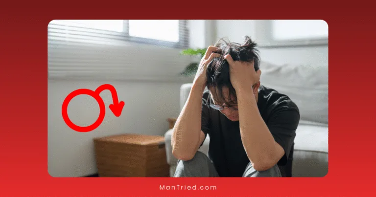 A man sits on the floor with his head in his hands, looking distressed, highlighting the link between ED and mental health. A red arrow with a male symbol points toward him in a bright room with a gray sofa and wooden box.