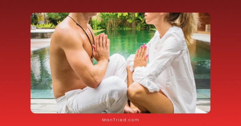 A man and woman sit facing each other in front of a pool, both dressed in white with hands in prayer position, embracing mindfulness and sharing a peaceful, meditative moment outdoors.