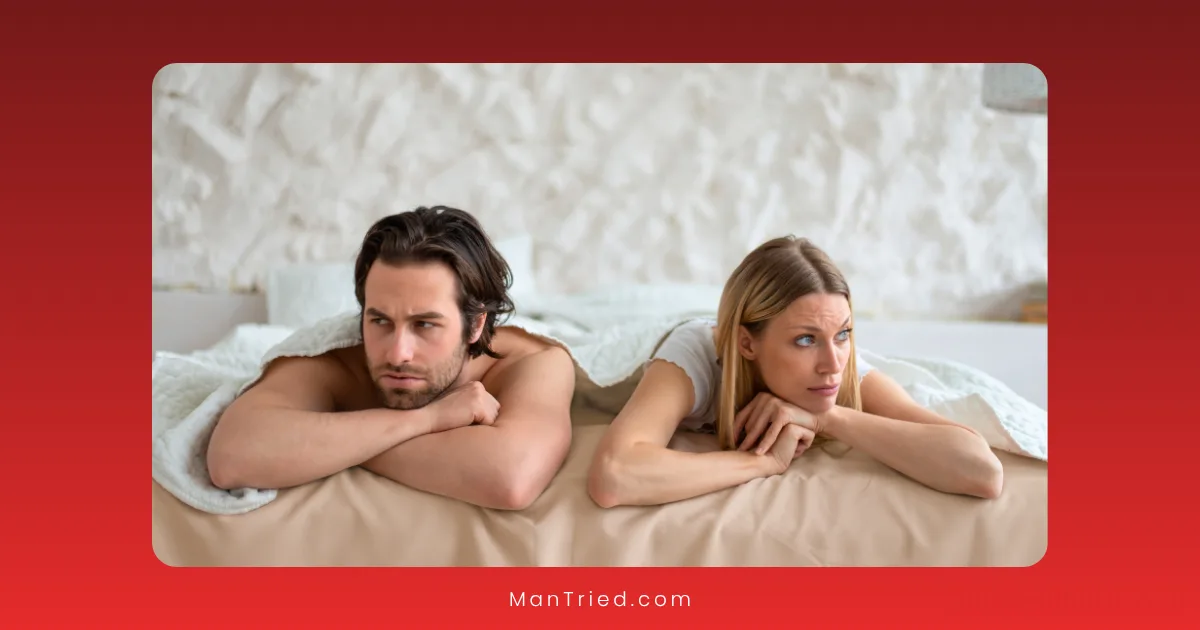 A man and woman lie side by side on a bed, both looking away from each other with serious expressions, suggesting tension or disagreement possibly due to mismatched libidos. The background is a white wall and bedding.