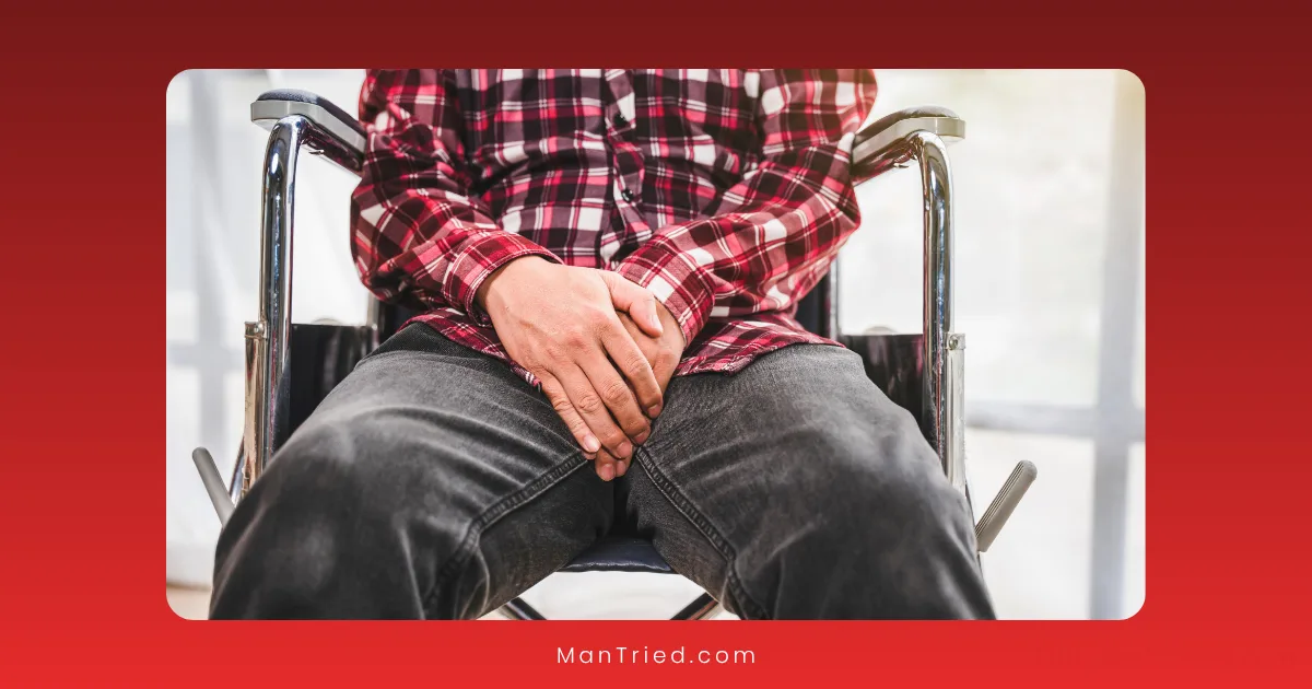 A person wearing a red plaid shirt and dark jeans sits in a wheelchair, hands protectively over their lap—capturing the challenges of post-surgery ED.