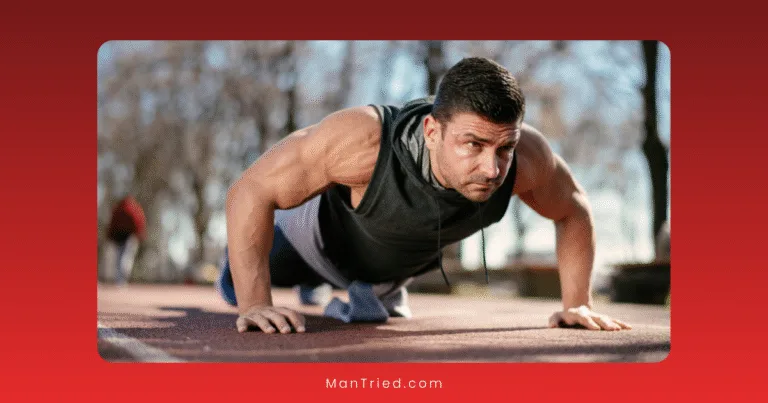 A muscular man in a sleeveless hoodie performs a push-up outdoors on a track, highlighting weight management for men over 40. Trees and a blurred person are visible in the background.