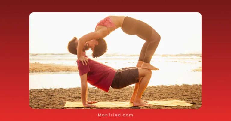 A man and a woman practice partner tantra exercises on a beach at sunset; the man supports himself in a crab pose while the woman arches backward over him, forming a graceful bridge.